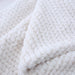 The close-up image highlights the texture and softness of the Hello Doggie Paris Dog Blanket in ivory