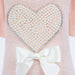 The detailed close-up of the Hello Doggie Pearl Heart Dog Sweater in peach color showcases the intricate pearl heart design with a white bow at the base