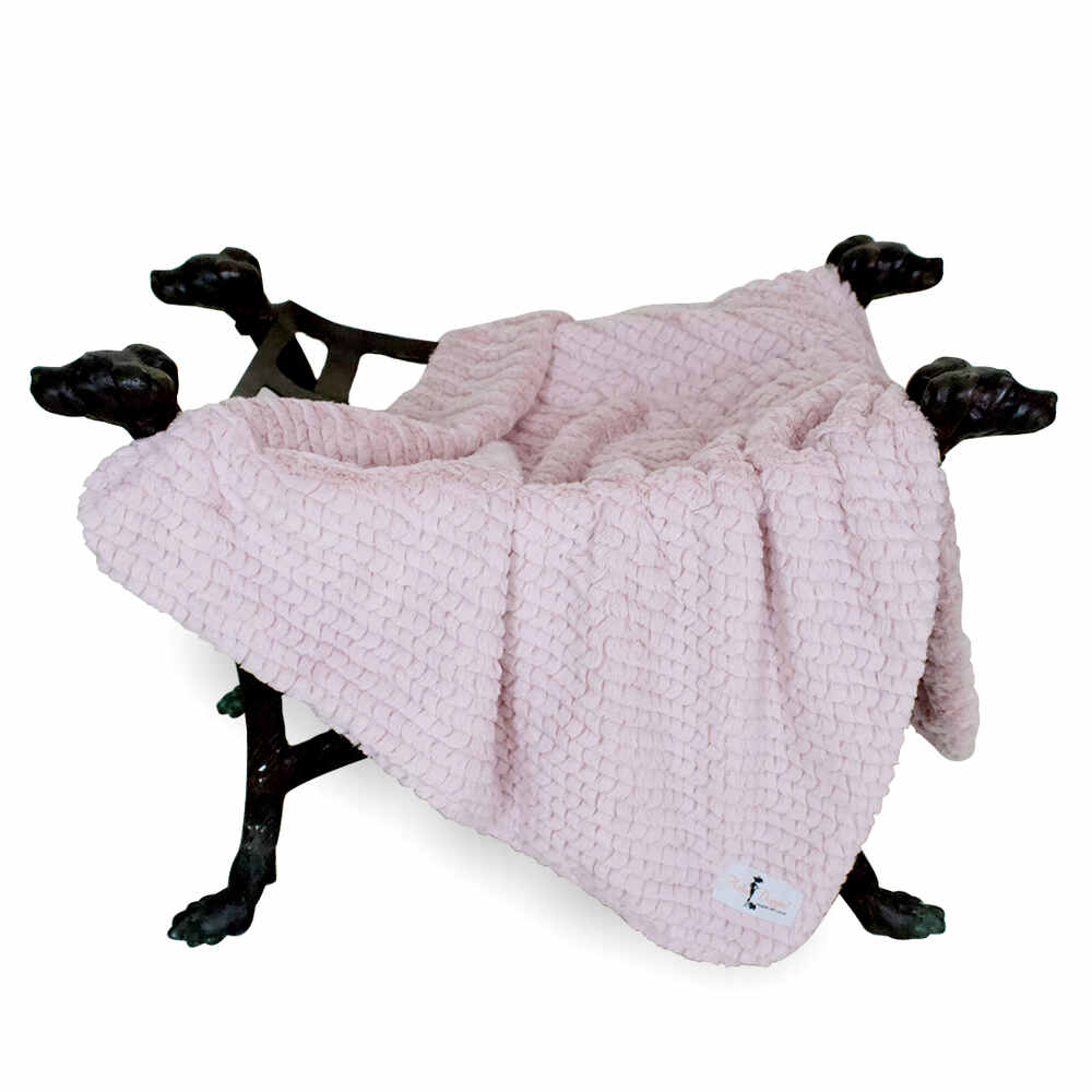 The image depicts a soft pink blanket arranged on a dog-themed stand, highlighting the Hello Doggie Paris Dog Blanket in rosewater