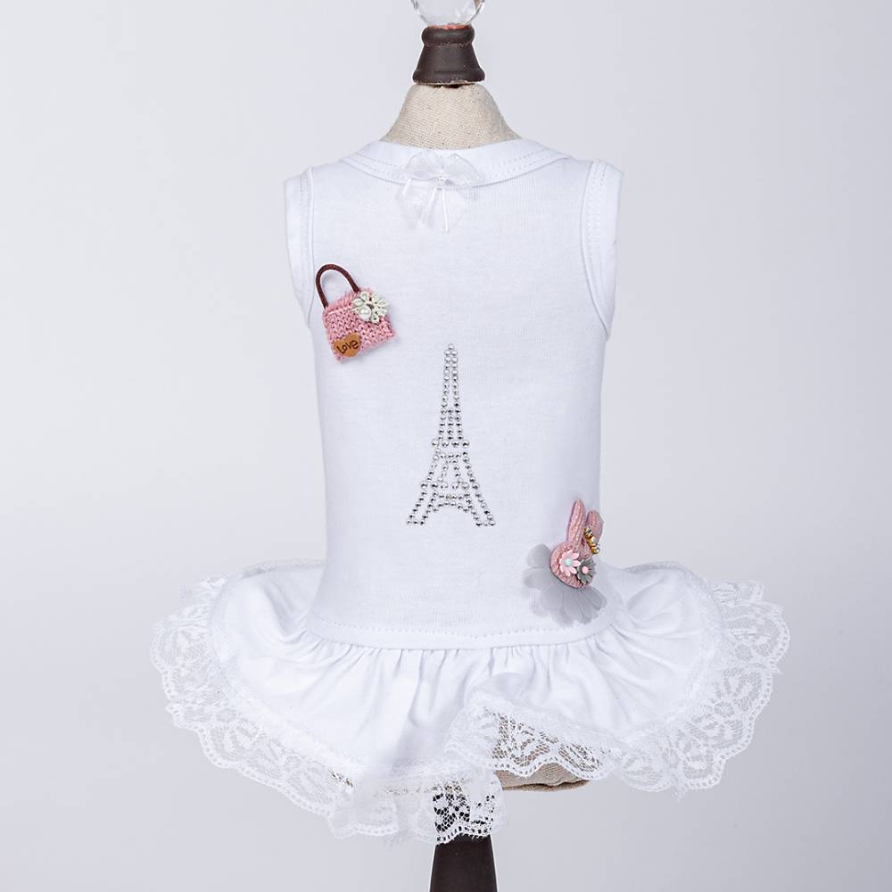The image depicts a white Hello Doggie Paris Dog Dress with the same rhinestone Eiffel Tower design, a pink handbag, and a bunny applique on the front