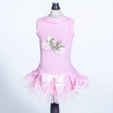 The image displays the Hello Doggie Bicycle Dog Dress, which is a pink dress featuring a decorative bicycle design with floral accents, and a frilly skirt with a large pink bow