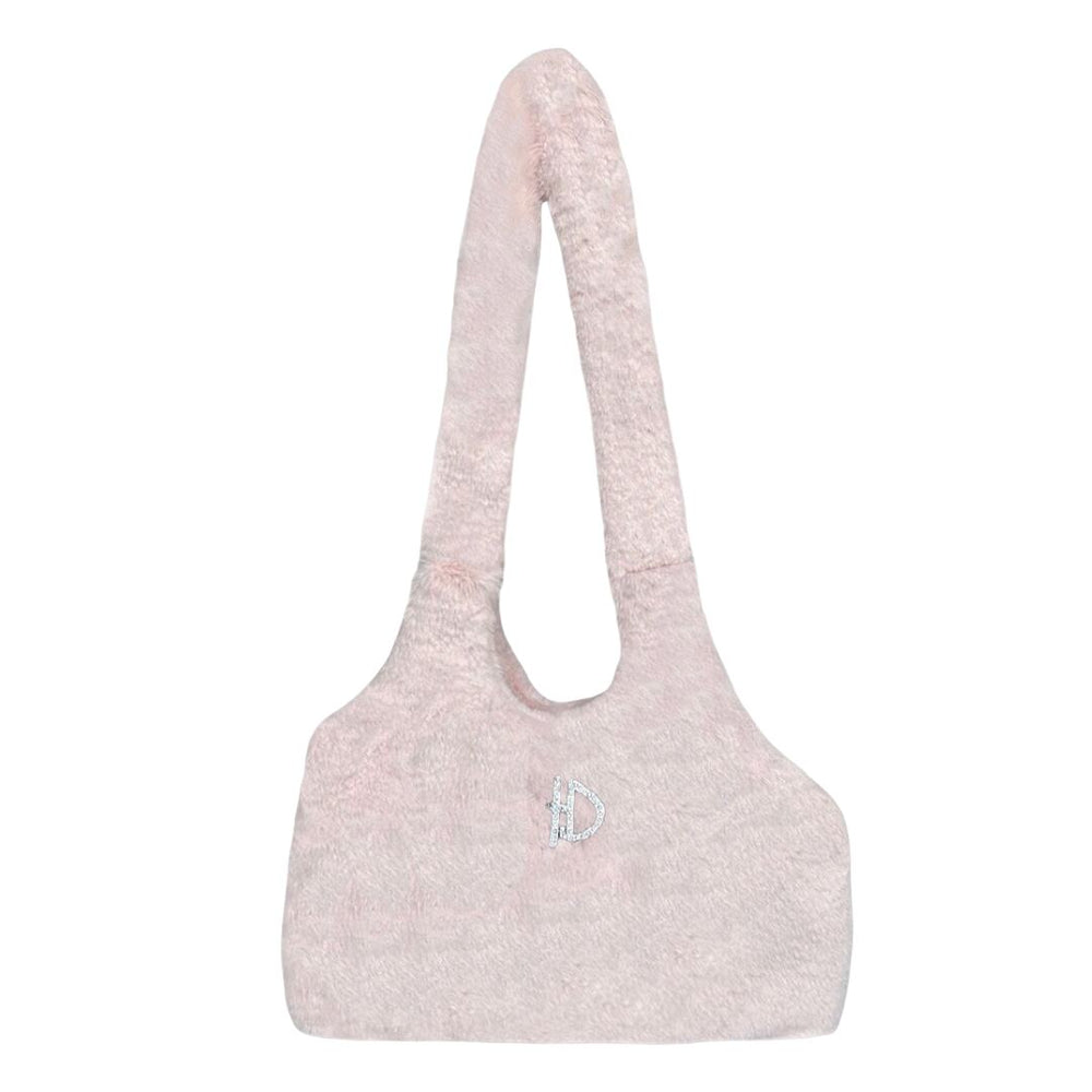 Theimage displays the back of the blush, fuzzy dog carrier, featuring a small, sparkly D emblem, named the Hello Doggie Divine Dog Carrier