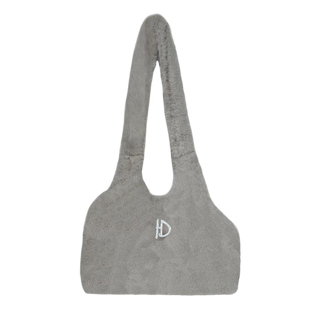 The image displays the back of the dove grey, soft dog carrier, featuring a small, sparkly D emblem, named the Hello Doggie Divine Dog Carrier