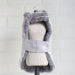 The image displays the back of the silver gray Hello Doggie Gia Dog Coat with the coat fully opened to show its inner lining and fastening strap