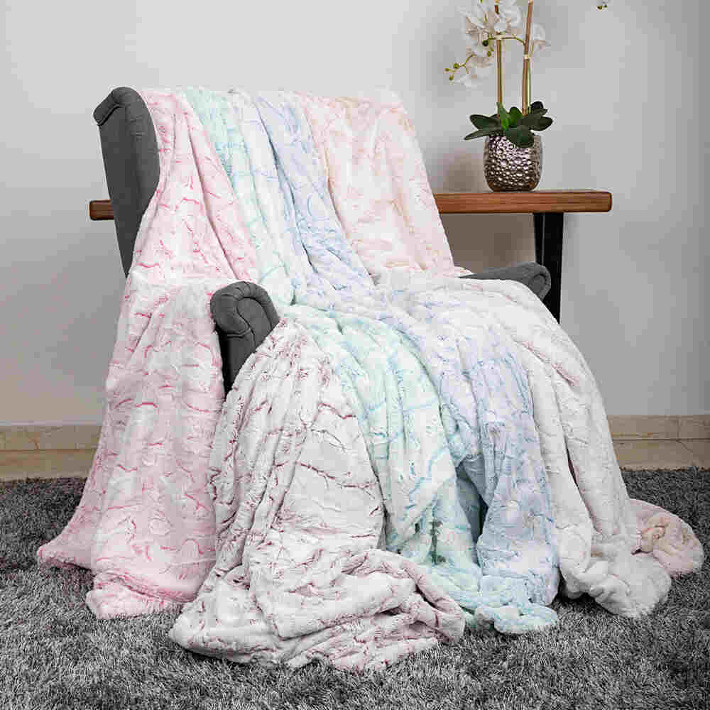 The image features multiple Hello Doggie Whisper Dog Blankets in various colors, all draped over a gray armchair, demonstrating their plush and cozy appeal