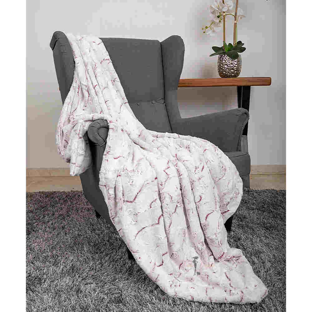 The image highlights the Hello Doggie Whisper Dog Blanket in merlot color, gracefully draped over a gray armchair, creating a luxurious ambiance
