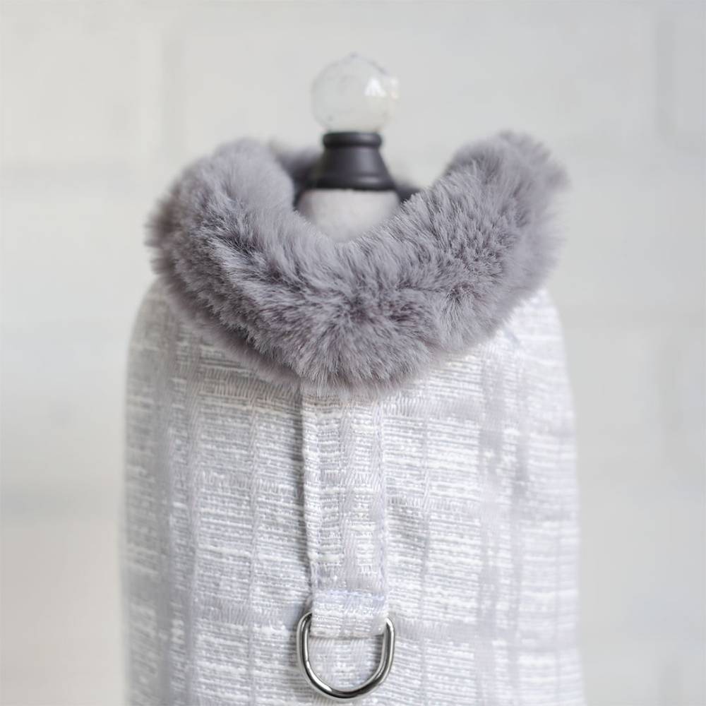 The image presents a close-up view of a silver gray Hello Doggie Gia Dog Coat with a fluffy faux fur collar and a shiny metal D-ring