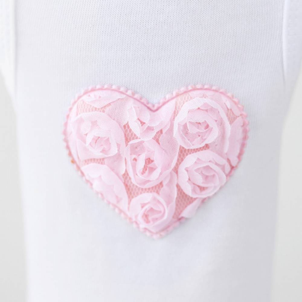 The image provides a close-up view of the pink heart detail on the Hello Doggie Puff Heart Dog Dress, showcasing the intricate rose pattern