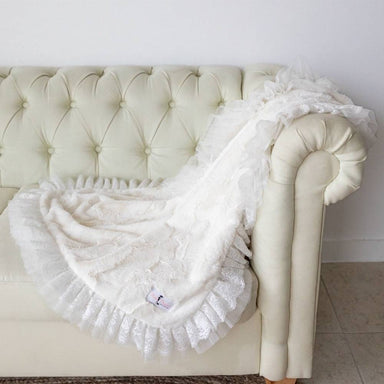 The image showcases a luxurious, cream-colored blanket draped over a cream sofa, highlighting the intricate lace details and soft texture of the Hello Doggie Romantic Dog Blanket