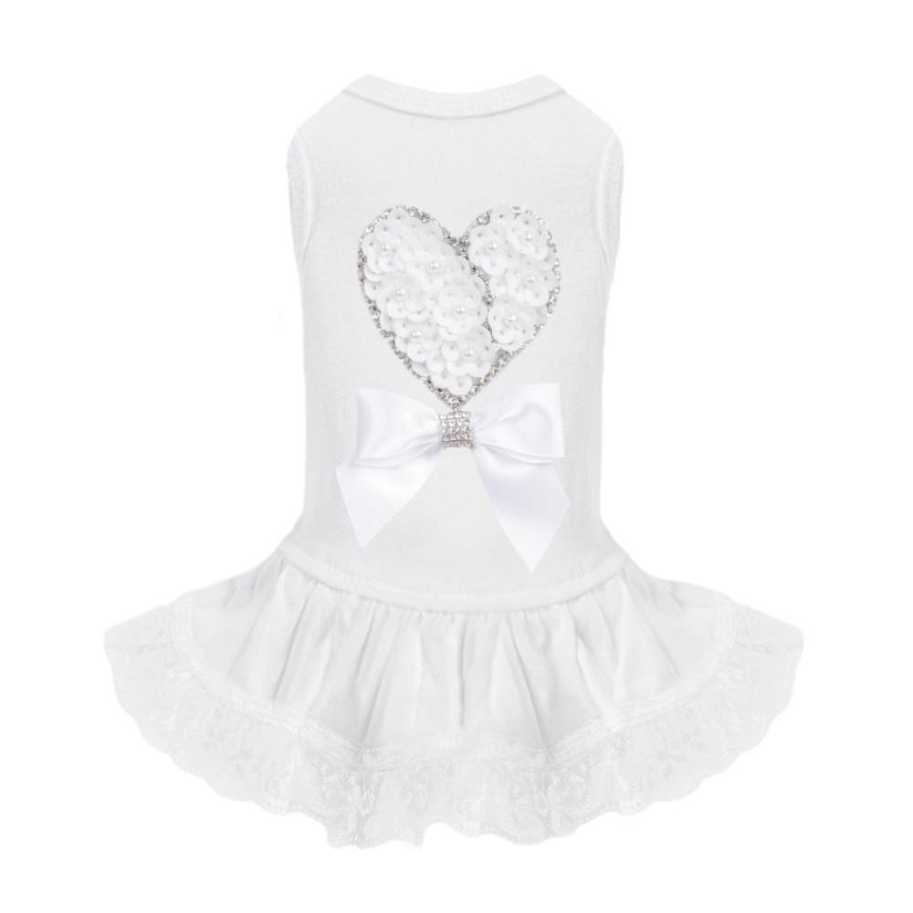The image showcases the Hello Doggie Endless Love Dog Dress, highlighting its white fabric, heart-shaped floral design adorned with pearls, and a satin bow