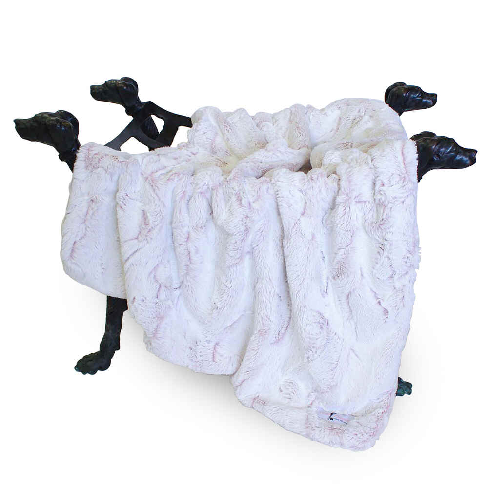 The image showcases the Hello Doggie Whisper Dog Blanket in baby pink color, elegantly displayed over four black dog head statues