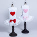 The image showcases two Hello Doggie Lacey Puff Heart Dog Dresses, one with a red heart and bow and the other with a light pink heart and bow