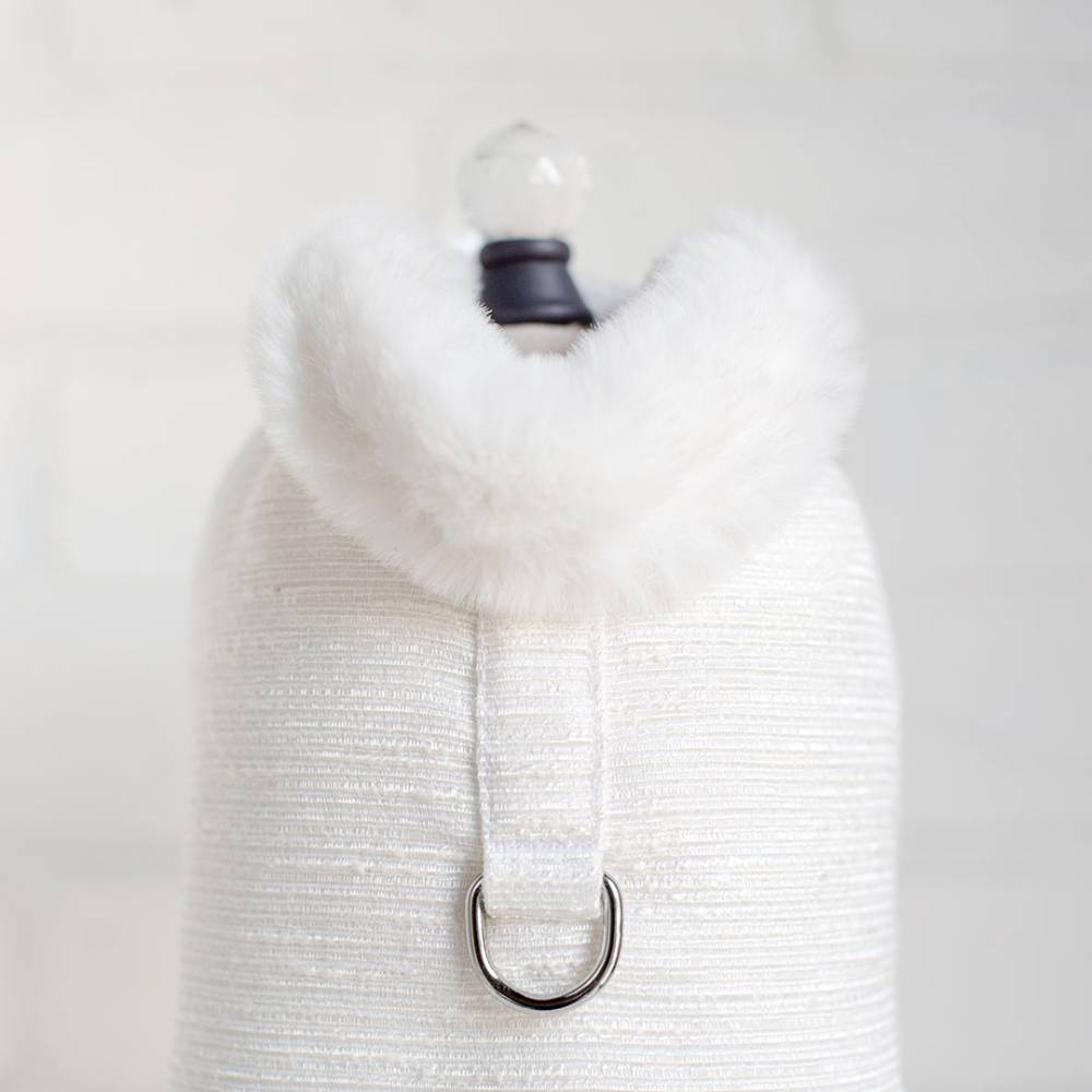 The image shows a close-up of the Hello Doggie Zha Zha Dog Coat in ivory white with a plush, fluffy collar and a D-ring for leash attachment