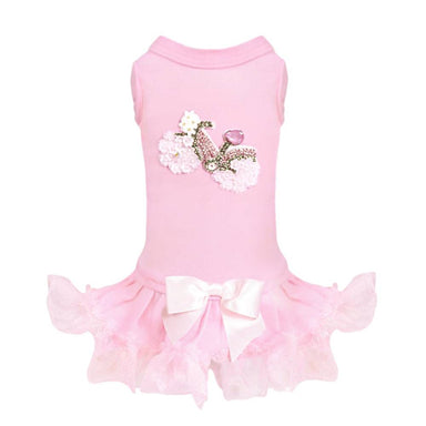 The image shows another view of the Hello Doggie Bicycle Dog Dress, highlighting a pink dress with a bicycle design adorned with flowers and a frilly skirt complemented by a large pink bow