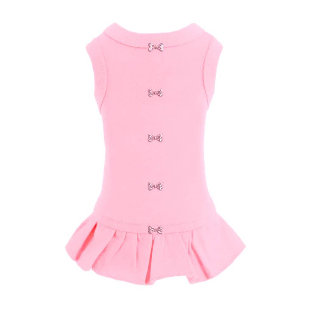 The image shows a pink Hello Doggie Candy Dog Dress with small decorative bows down the back and a ruffled hem