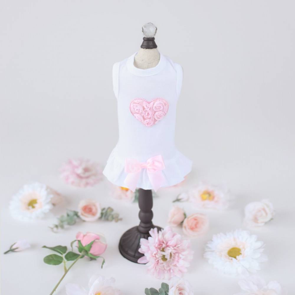 The image shows the Hello Doggie Puff Heart Dog Dress in pink, displayed on a mannequin surrounded by pastel flowers