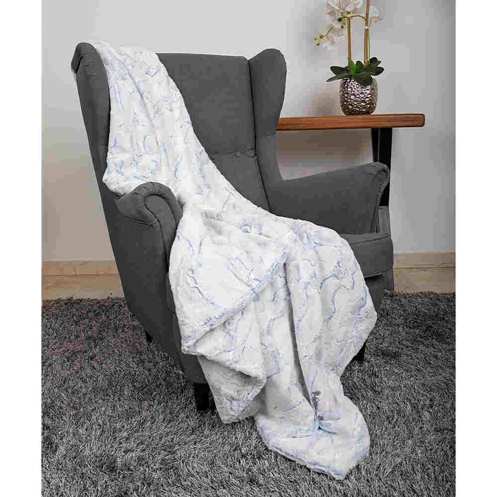 The image shows the Hello Doggie Whisper Dog Blanket in baby blue color, draped over a gray armchair in a cozy setting