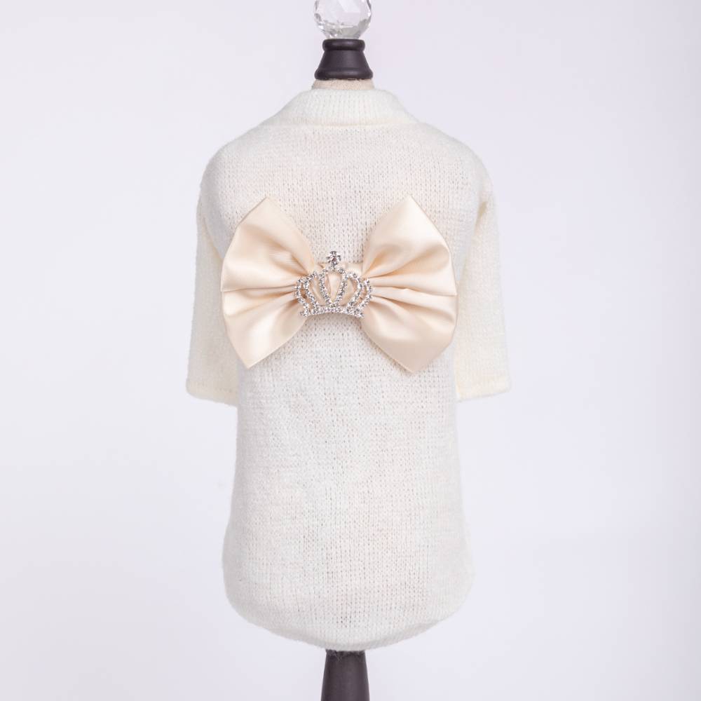 The image shows the back of a Hello Doggie Royal Princess Dog Sweater in cream color, featuring a large satin bow with a rhinestone crown in the center