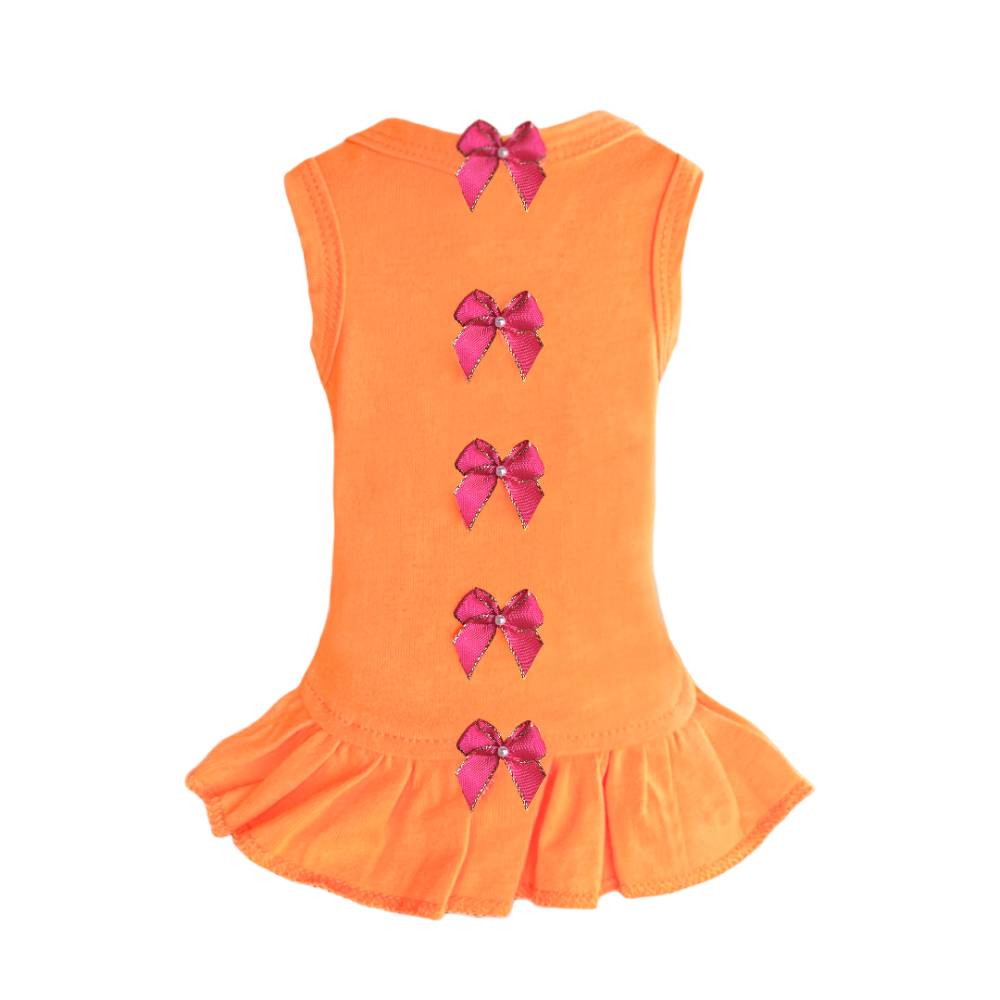 The image shows the back of an orange dress adorned with pink bows and a ruffled bottom, identified as the Hello Doggie Summer Dreams Dog Dress
