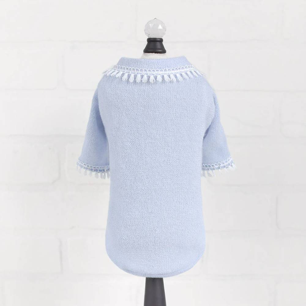 The image shows the back view of a baby blue sweater with a tassel fringe decoration around the neckline and sleeve edges, identified as Hello Doggie Heavenly Kiss Dog Sweater