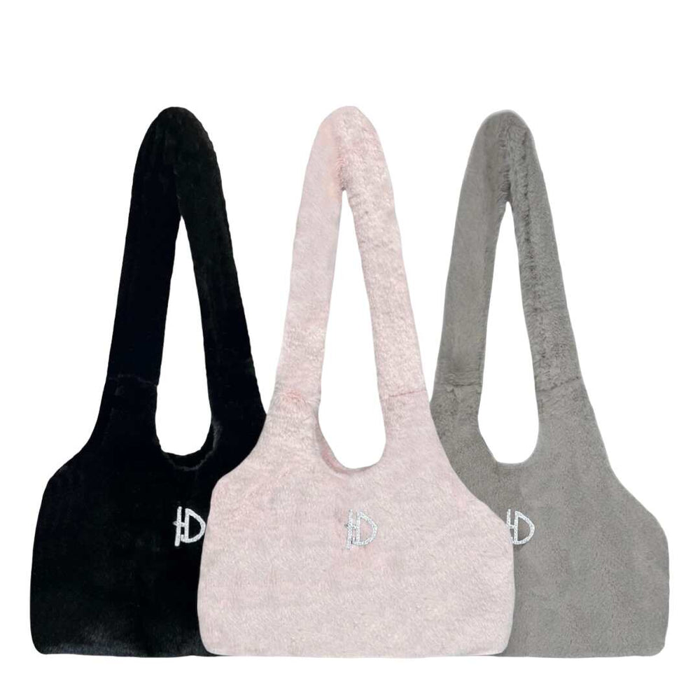 The image shows three Hello Doggie Divine Dog Carrier bags in caviar, blush pink, and dove grey, each featuring a soft, plush design with a small sparkly D emblem