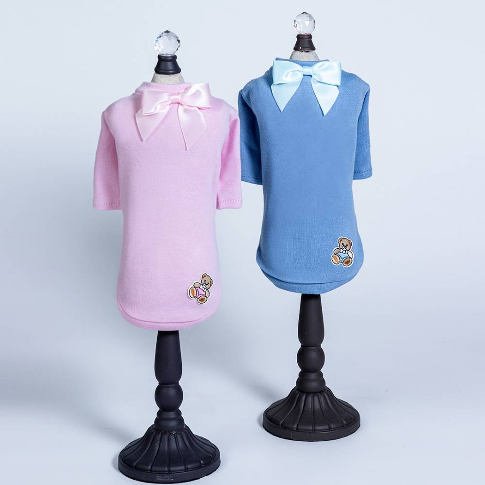 The image shows two Hello Doggie Baby Bear Dog Tee outfits in pink and blue, each featuring a bow at the neck and a small teddy bear patch at the bottom