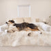 The tricolor dog is fully stretched out on the Paw PupProtector™ Waterproof Couch Lounger - Polar White on a bed
