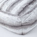 This close-up image of the Hello Doggie Big Baby Bed in angora color showcases the intricate pattern of the faux fur fabric
