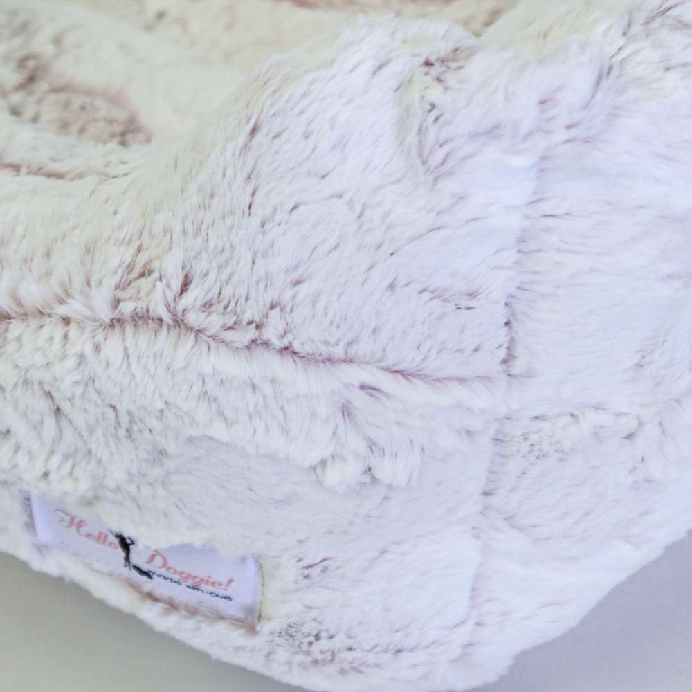 This close-up image shows the Hello Doggie Whisper Dog Bed in baby pink, focusing on the plush and soft texture of the bed