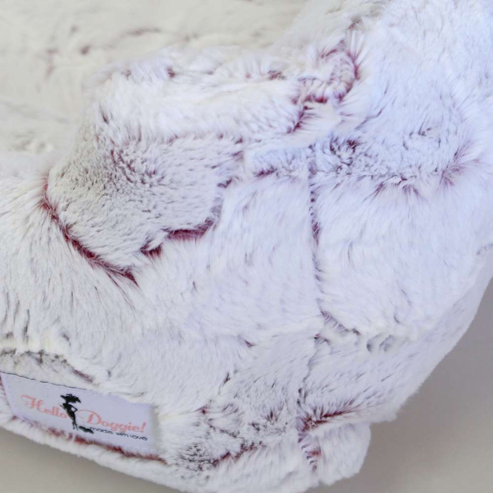 This image shows a detailed close-up of the Hello Doggie Whisper Dog Bed in a merlot color