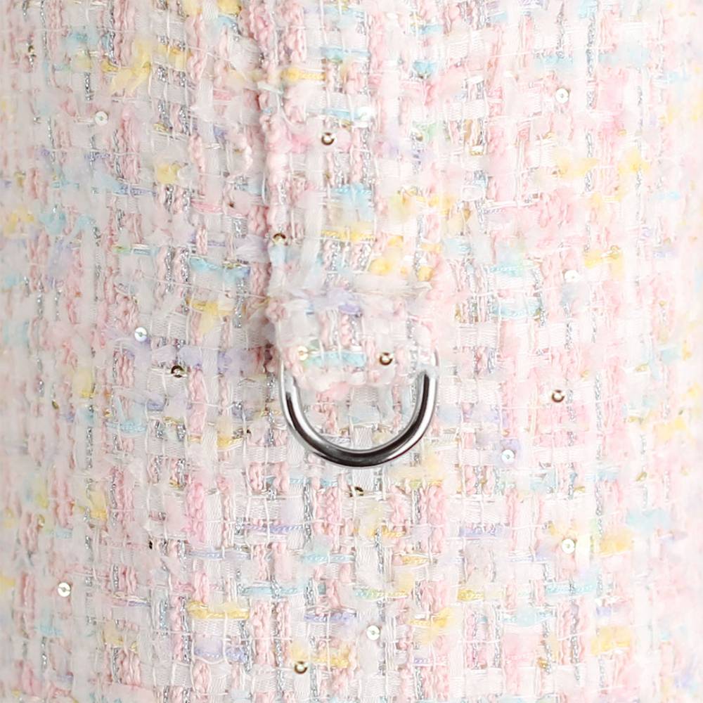 This photo presents a close-up of the pastel candy tweed dog coat's attachment ring and fabric texture, named the Hello Doggie Chantel Tweed Dog Coat