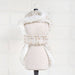 This photo shows the back view of the cream tweed dog coat, highlighting its elegant design and cozy interior, called the Hello Doggie Chantel Tweed Dog Coat