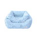 Two Hello Doggie Bella Dog Beds in baby blue, showcasing small and large sizes, stacked together to display the size variation and fluffy, inviting texture