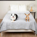 Two dogs are sitting on a bed covered with the Paw PupChill™ Cooling Waterproof Blanket - Arctic Grey Dog Blankets